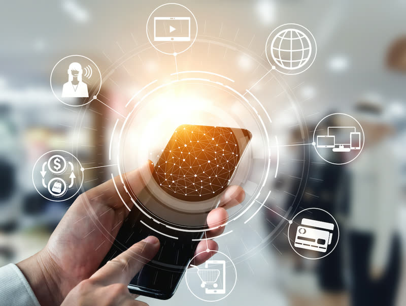 Hand holding a phone surrounded by digital banking service icons