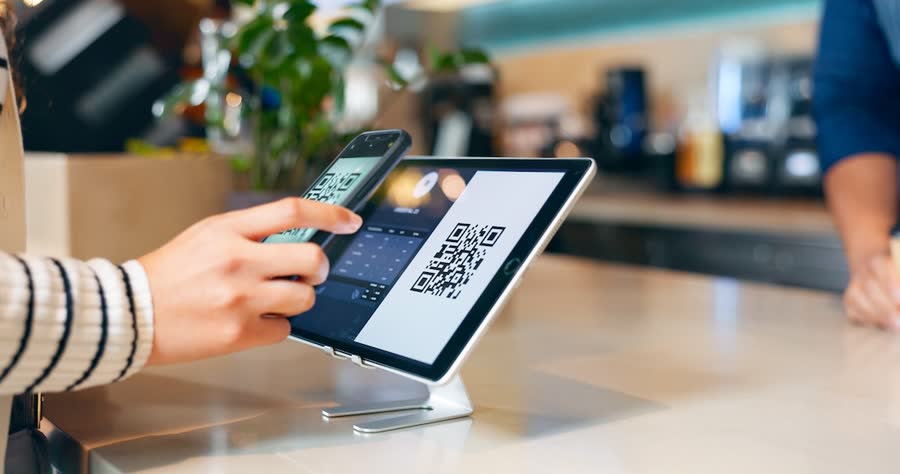 Customer scanning a QR code at a checkout tablet