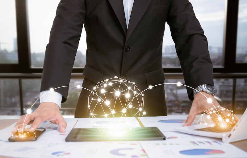Businessman with digital network visualization over documents